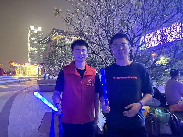 图1志愿者向路人宣传讲解自闭症知识.JPG
